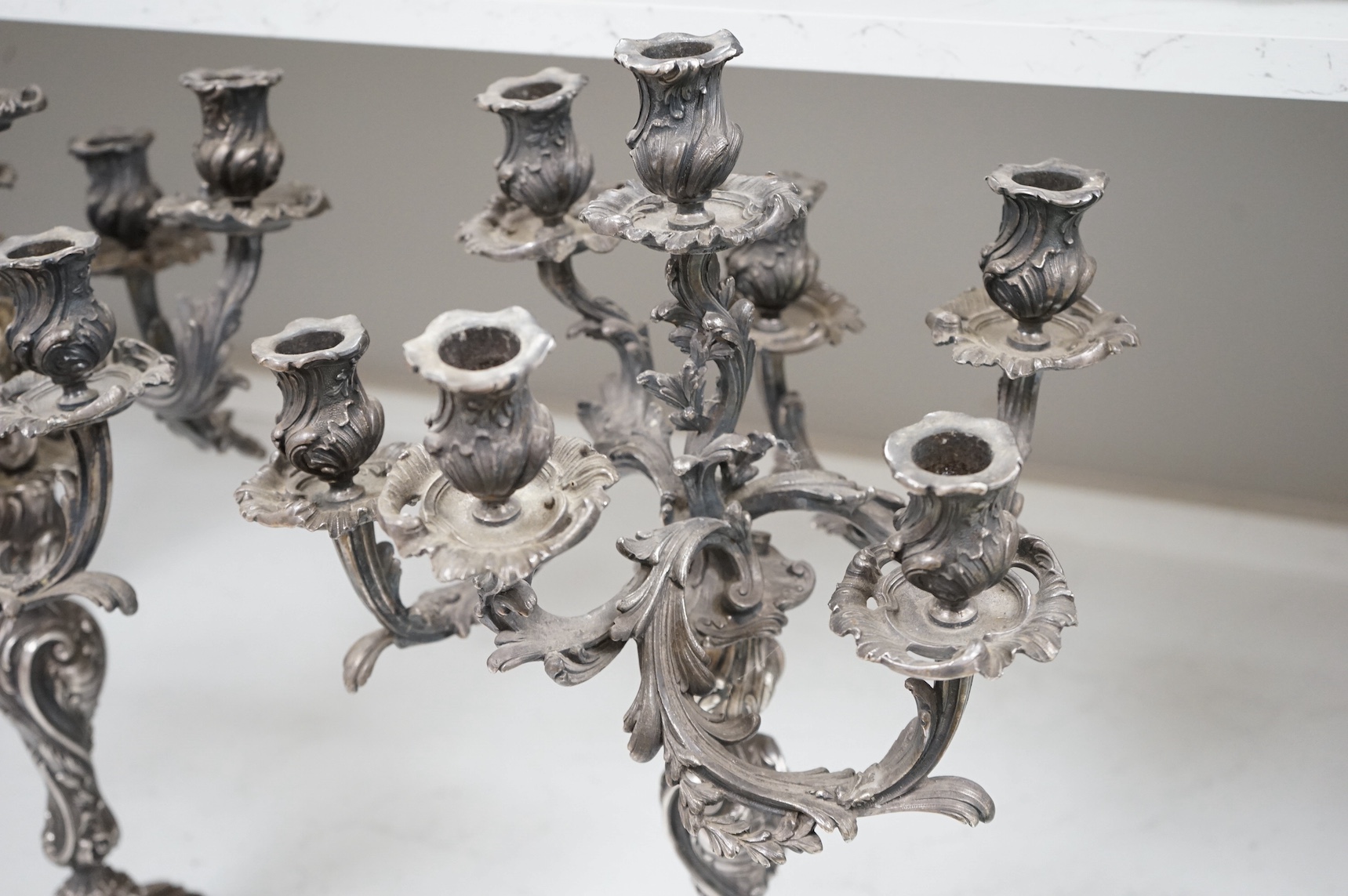 A pair of silver plated Rococo style six branch, seven light candelabra, 49cm. Condition - fair to good